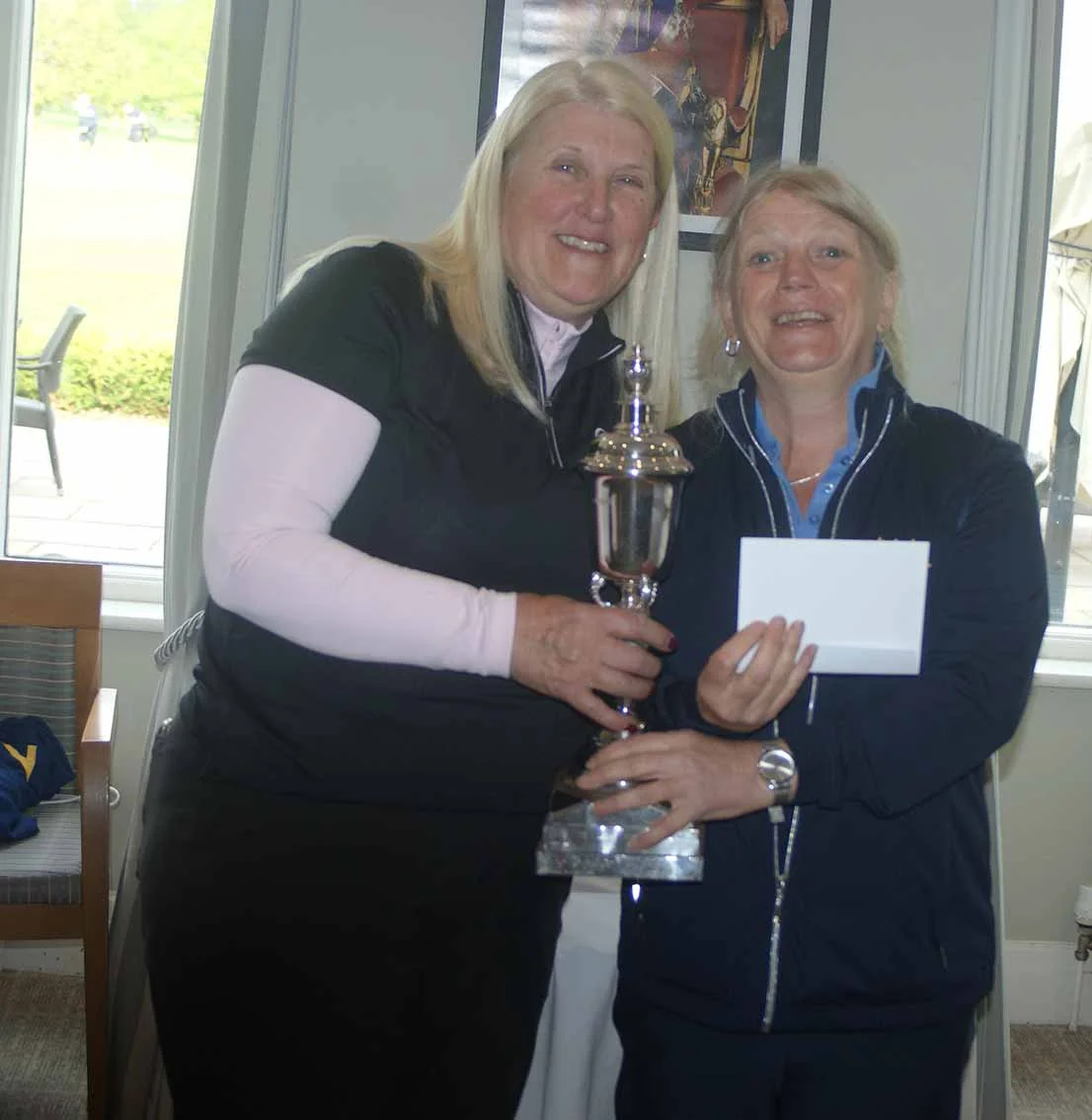 Sara receives the trophy to mark her remarkable treble